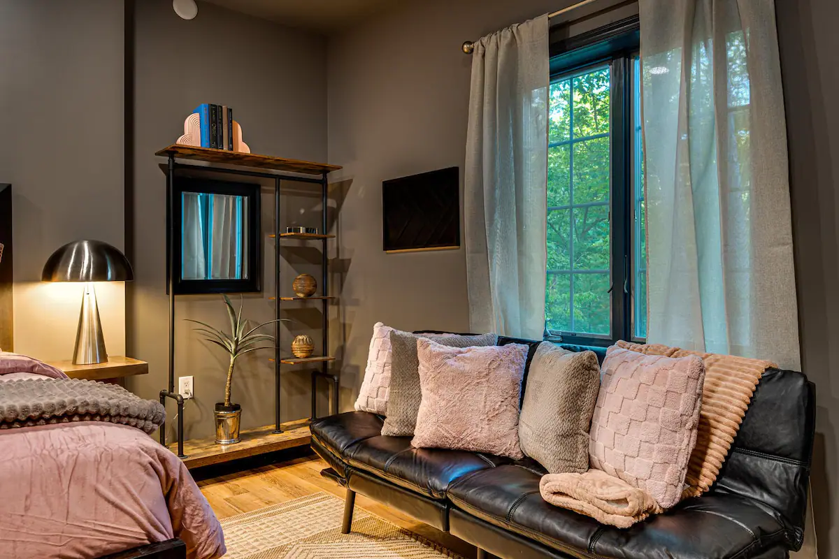 The Retreat's Queen Bedroom with Futon: Featuring a comfortable queen bed and versatile futon for extra seating or sleeping arrangements.